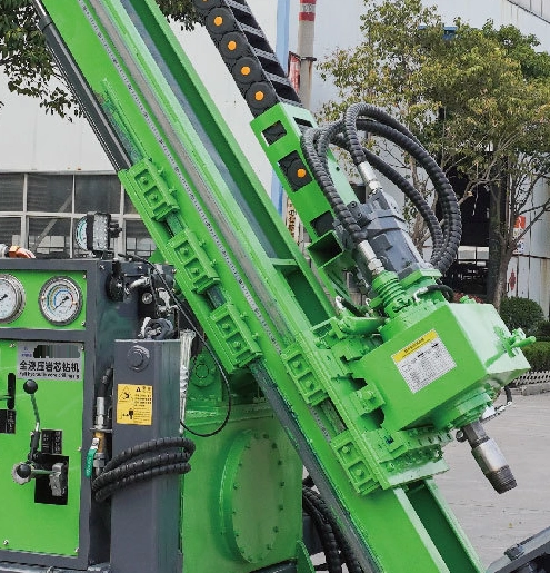 DR-1000X Core Drilling Rig rotary head, hydraulic connections and articulated hose carrier