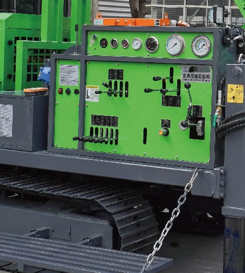 DR-1000X Core Drilling Rig side console with gauges, control levers and fold-down operating platform