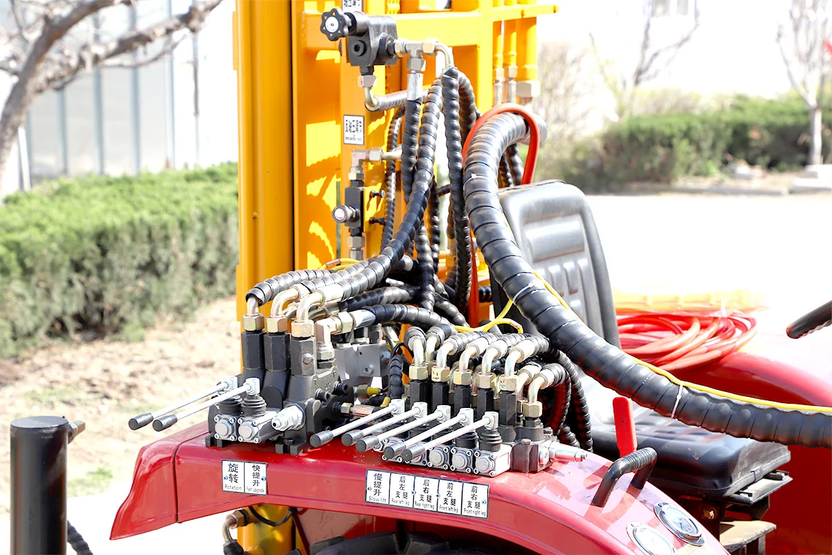 DR-600 hydraulic valve banks and labeled levers beside the operator seat
