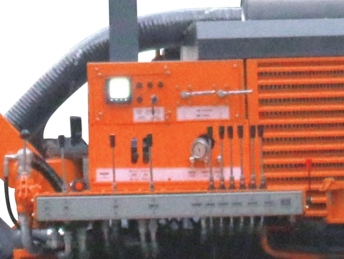 DR-90T side console with grouped levers, switches, a display and a circular gauge